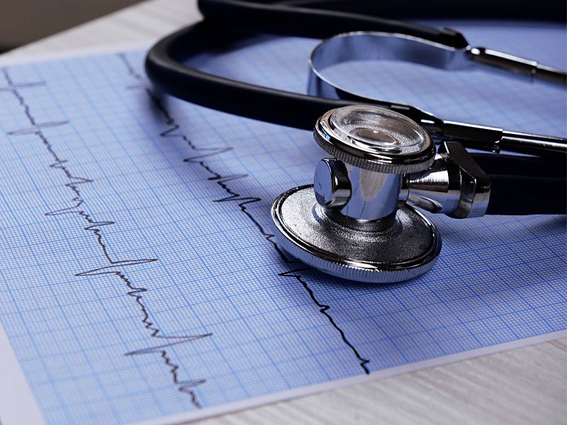 Lab results page and a stethoscope on a desk