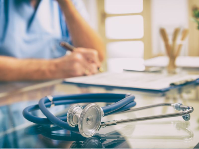 Image of a doctor sitting at a desk